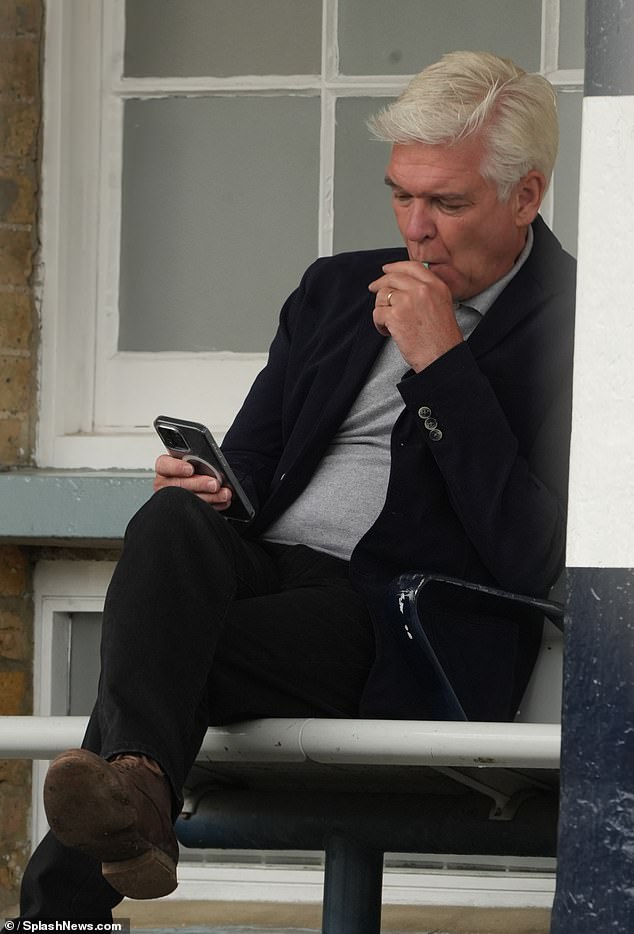 Phillip Schofield was spotted smoking an e-cigarette at a train station in West London - despite all forms of smoking being banned